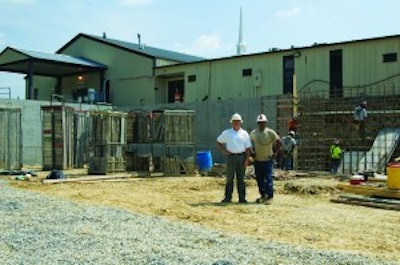 Tim Parrish, left, president of Cornerstone Foundations, and TC Curry, right, a project manager with the company, on site at a building addition project at a Virginia church.