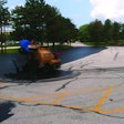 The parking lots were sealed using two SealMaster SP 300 squeegee machines which Sonnenberg outfitted with custom-made 18- to 24-in. brooms on the back of the units.