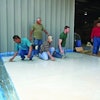 Mike Emma and Kurt Ziegler, kneeling on right, attended a skim coating class at the Decorative Concrete Institute four days after returning home from a tour of duty in Iraq.