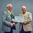 Bob Long (left), on behalf of Thermomass, accepts the 2013 Tilt-Up Concrete Association Robert Aiken Innovation Award from TCA Executive Director Ed Sauter (right).