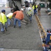 Speed Screed Cruiser, used in paving Sonoma County bus yard, includes extensions that allow variable paving widths and crown variations.