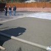 Finishing the pervious concrete was done with roller-screed strike-off, covered with plastic and rolled, and then received a plastic cover cure.