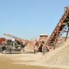 The Sandvik QI240 is a 43-ton crusher that moves on 20-inch-wide tracks and can be transported by trailer.