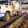 Transit mixers worked inside metal paving forms, sometimes hauling as many as 120 truckloads a night, to repave gate areas at Phoenix Sky Harbor International Airport.