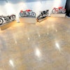 Layers of paint, epoxy, carpeting, luxury vinyl tile and vinyl composite tile once covered the floor at the Moto Museum in St. Louis, which houses some of the rarest motorcycles in the existence.