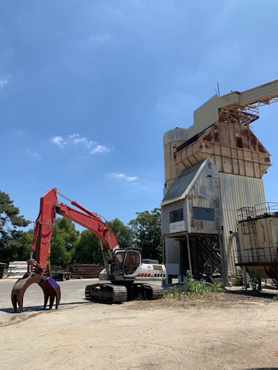 A Link-Belt 330LX excavator with a LaBounty grapple pulled structures safely to the ground after strategic cuts in the vertical steel on this no-explosives demolition.