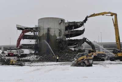 The post-tensioned, four-story parking garage, built in 1990, with concrete reaching 20,000 psi was an impressive demolition challenge.