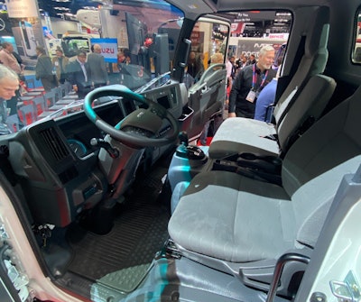 The Isuzu N-Series EV's new cab features a steering wheel hub that contains switches that operate the multi-information display, audio system, cruise control and hands-free phone calling, and a 7-inch color multi-information display housing warning lights, status indicators of driver-assistance features, time and temperature, odometer, fuel gauge and shift position indicator.