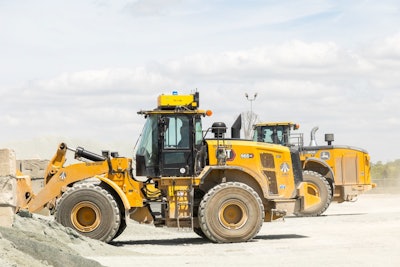 Caterpillar 966XE wheel loader equipped with Teleo Supervised Autonomy at an Ajax Paving asphalt plant.