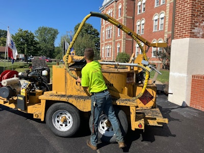 Pave Care employee Christian Shaffer crack sealing for a paving project at Eire Veterans Home.