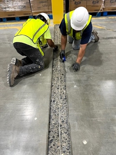 Concrete contractors widened a structural joint for repair.