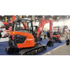 Orange Kubota excavators displayed at construction equipment trade show