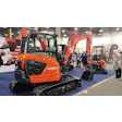 Orange Kubota excavators displayed at construction equipment trade show