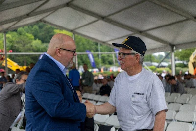 Komatsu North America CEO Rod Bull (left) thanks employee David Dolan for his years of service at Komatsu's Chattanooga Manufacturing Operation (CMO). Dolan joined Komatsu in 1986 and is the most tenured employee at CMO.