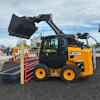 Yellow and black JCB L250 telehandler with raised bucket attachment at equipment dealership
