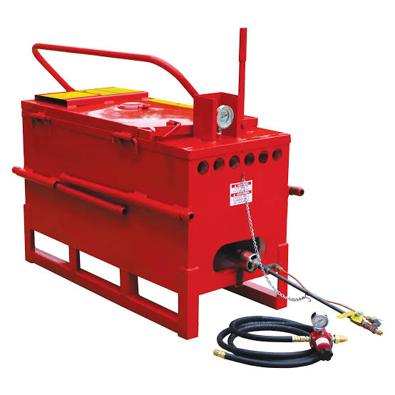 Red hydraulic pressure washer with yellow top, pressure gauge, and attached hose assembly