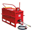 Red hydraulic pressure washer with yellow top, pressure gauge, and attached hose assembly