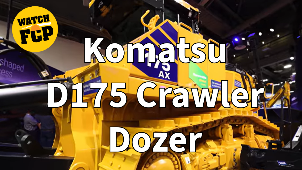 Yellow and blue Komatsu D175 Crawler Dozer on display at an indoor equipment showroom with 'WATCH FCP' badge overlay