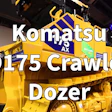 Yellow and blue Komatsu D175 Crawler Dozer on display at an indoor equipment showroom with 'WATCH FCP' badge overlay