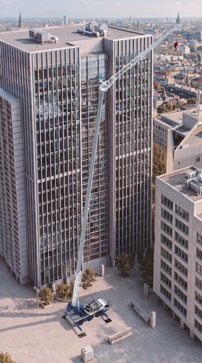 Modern skyscraper with vertical ribbed facade and construction crane against urban cityscape skyline